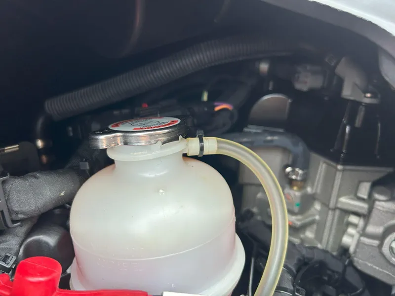 Slide: The Image of Close-up of 2021 Sea-Doo Spark Trixx 3up iBR engine compartment, showing coolant reservoir. - 14