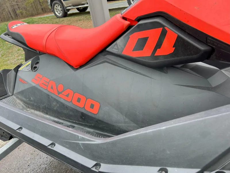Slide: The Image of 2021 Sea-Doo Spark Trixx 3up iBR with sound system, red and black design. - 3