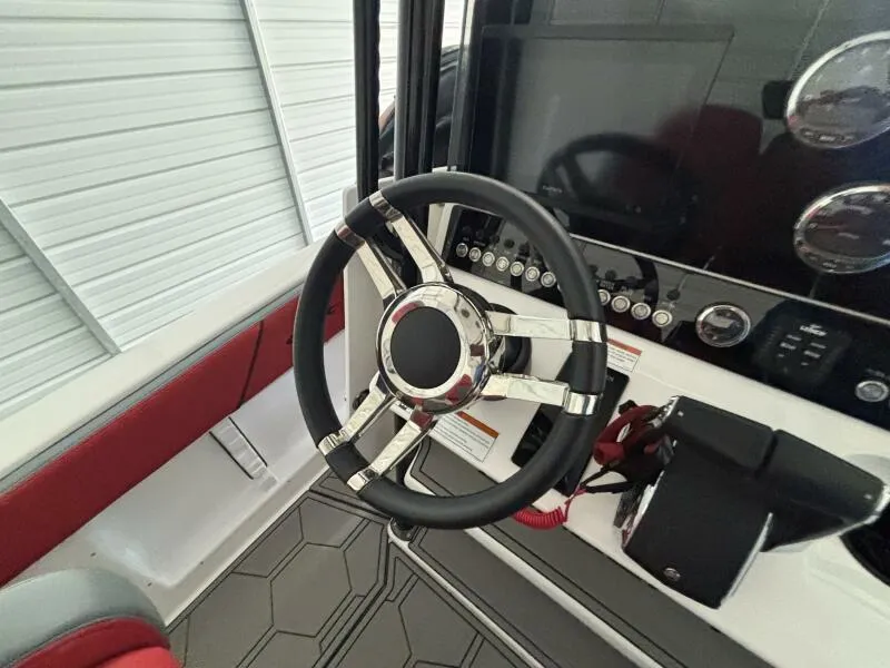 Slide: The Image of Steering wheel of 2025 Concept 27' Open Deck boat, featuring modern dashboard controls. - 13