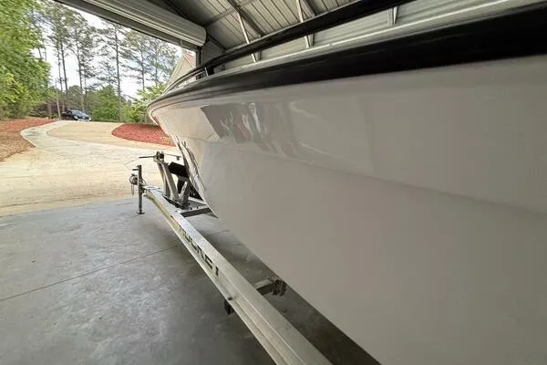 Slide: The Image of 2025 Concept 27' Open Deck boat on trailer in garage setting. - 16
