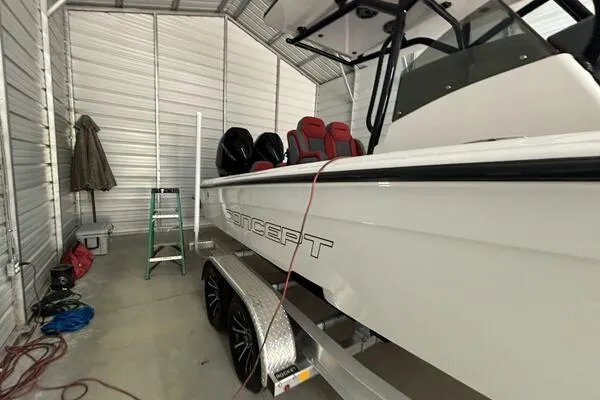 Slide: The Image of 2025 Concept 27' Open Deck boat in storage, featuring sleek design and modern seating. - 2