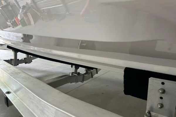 Slide: The Image of 2025 Concept 27' Open Deck boat on trailer, close-up view of hull and support. - 23