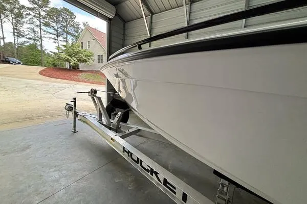 Slide: The Image of 2025 Concept 27' Open Deck boat on trailer in garage setting. - 25