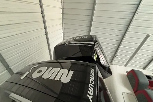 Slide: The Image of 2025 Concept 27' Open Deck boat with Mercury engines in a metal-roofed storage facility. - 34