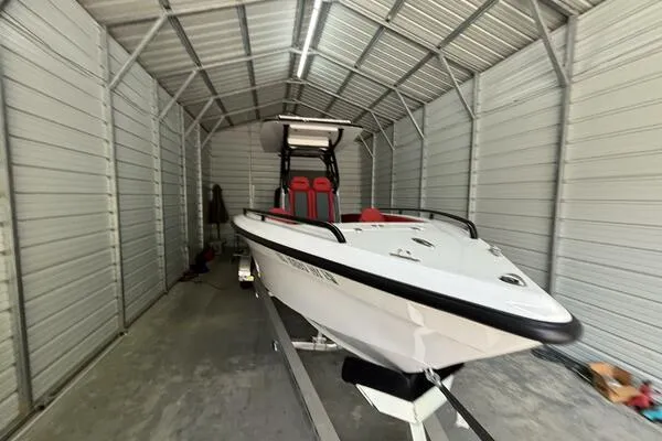 Slide: The Image of 2025 Concept 27' Open Deck boat in a metal storage shed. - 4