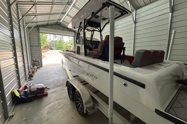 Slide: The Image of 2025 Concept 27' Open Deck boat in a metal garage, on a trailer. - 7