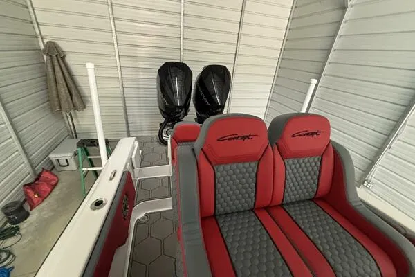 Slide: The Image of 2025 Concept 27' Open Deck boat with red and gray seating in a storage unit. - 8