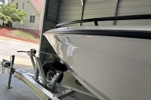 Slide: The Image of 2025 Concept 27' Open Deck boat on trailer in garage. - 9