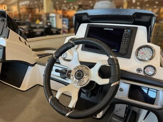Slide: The Image of 2024 Nitro Z20 Pro boat dashboard with steering wheel and navigation display. - 2