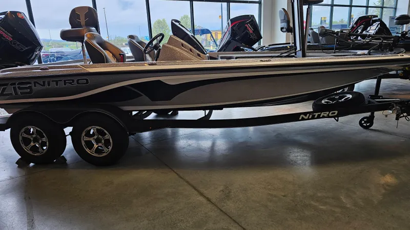 Slide: The Image of 2024 Nitro Z19 Pro boat on display in showroom, side view. - 1