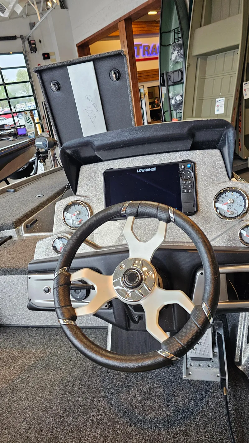 Slide: The Image of 2024 Nitro Z19 Pro boat dashboard with steering wheel and control panel. - 2