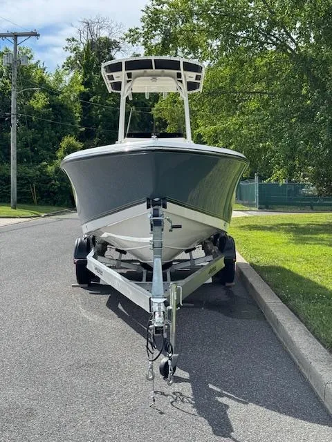 Slide: The Image of 2025 Mako 214 CC boat on trailer, parked on a sunny street. - 4