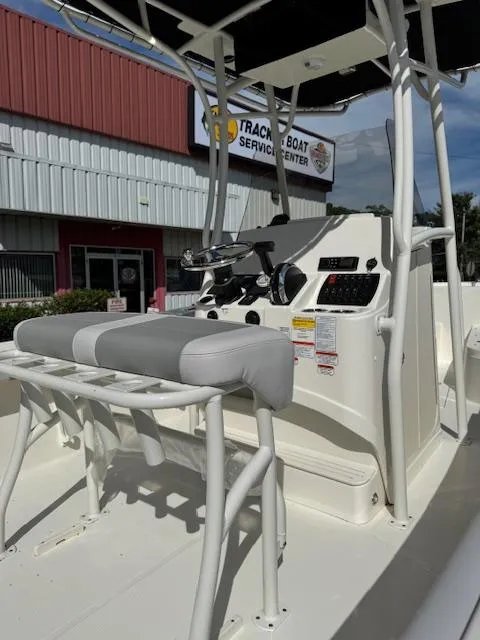 Slide: The Image of 2025 Mako 214 CC boat interior with console and seating, outside a service center. - 8