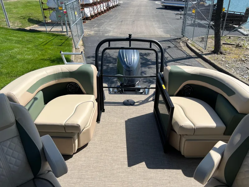 Slide: The Image of 2025 Godfrey Sweetwater 2286 Quad Social Tri-Toon boat interior with plush seating and outboard motor. - 16