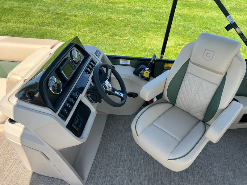 Slide: The Image of 2025 Godfrey Sweetwater 2286 Quad Social Tri-Toon helm with luxurious captain's chair and control panel. - 21