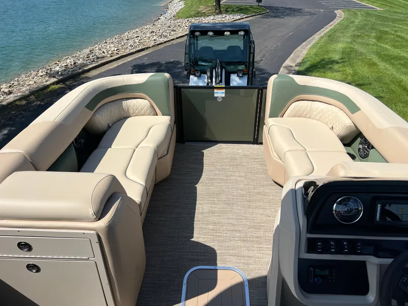 Slide: The Image of 2025 Godfrey Sweetwater 2286 Quad Social Tri-Toon interior with plush seating and modern dashboard. - 25