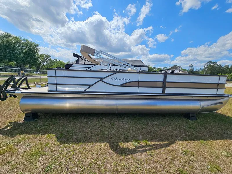 Slide: The Image of 2025 Bentley Pontoons 240 4-Point Fish on grass under blue sky. - 1