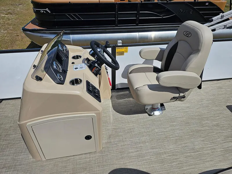 Slide: The Image of 2025 Bentley Pontoons 240 4-Point Fish helm with beige captain's chair and control panel. - 16