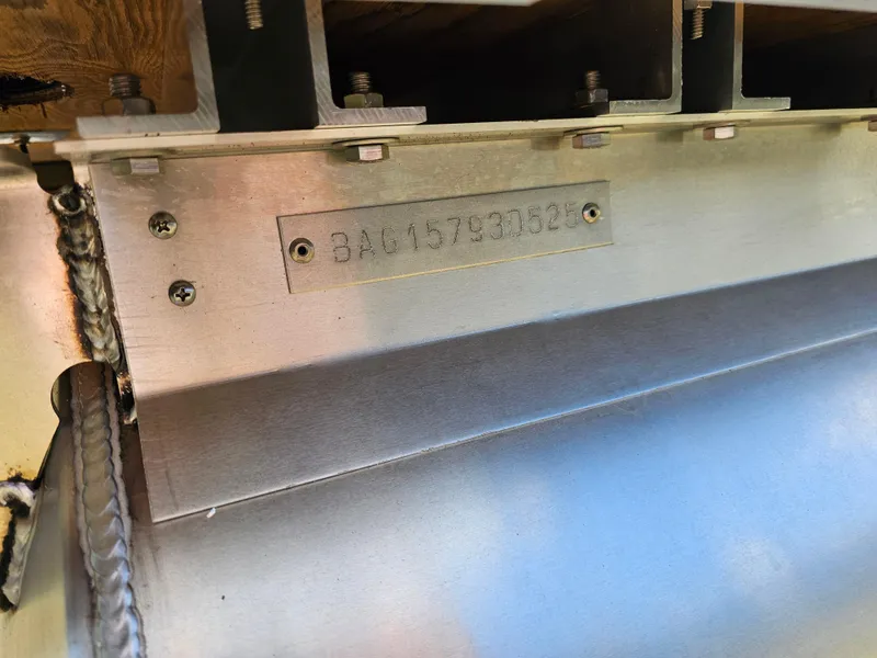 Slide: The Image of 2025 Bentley Pontoons 240 4-Point Fish, close-up of metal serial number plate. - 23