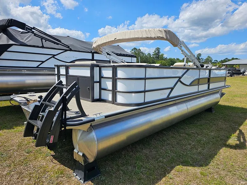 Slide: The Image of 2025 Bentley Pontoons 240 4-Point Fish pontoon boat on grassy area under blue sky. - 3