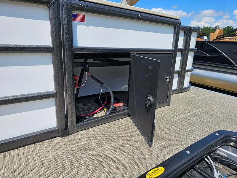 Slide: The Image of 2025 Bentley Pontoons 240 4-Point Fish storage compartment with open door, revealing interior wiring. - 8