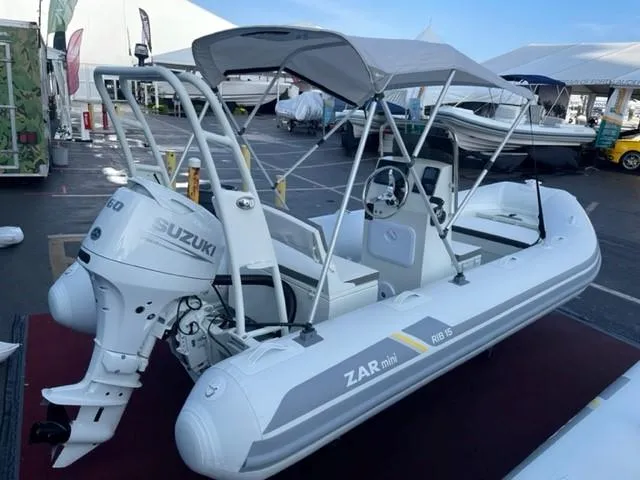 Slide: The Image of 2024 ZAR Mini RIB 15 Tender with Suzuki outboard engine, showcased at a boat exhibition. - 14