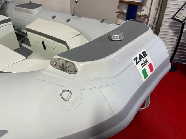 Slide: The Image of 2024 ZAR Mini RIB 15 Tender inflatable boat on display, featuring sleek design and Italian flag. - 2