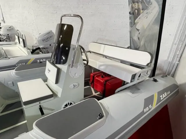 Slide: The Image of 2024 ZAR Mini RIB 15 Tender boat with seating and steering console in showroom. - 4