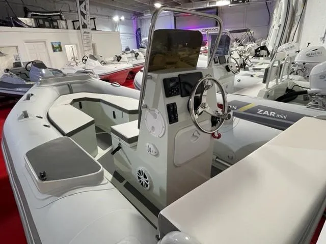 Slide: The Image of 2024 ZAR Mini RIB 15 Tender boat interior with steering console and seating. - 6
