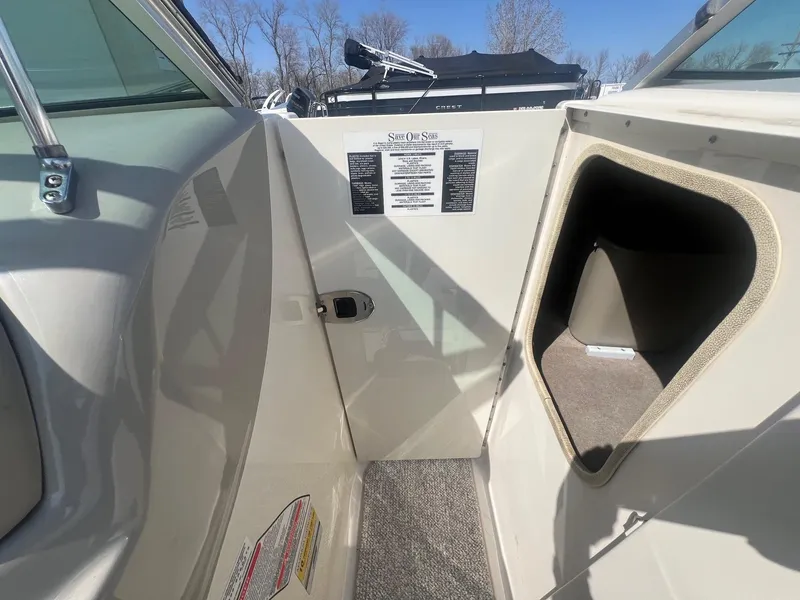 Slide: The Image of 2005 Sea Ray 220 Select boat interior with storage compartment and safety instructions. - 11
