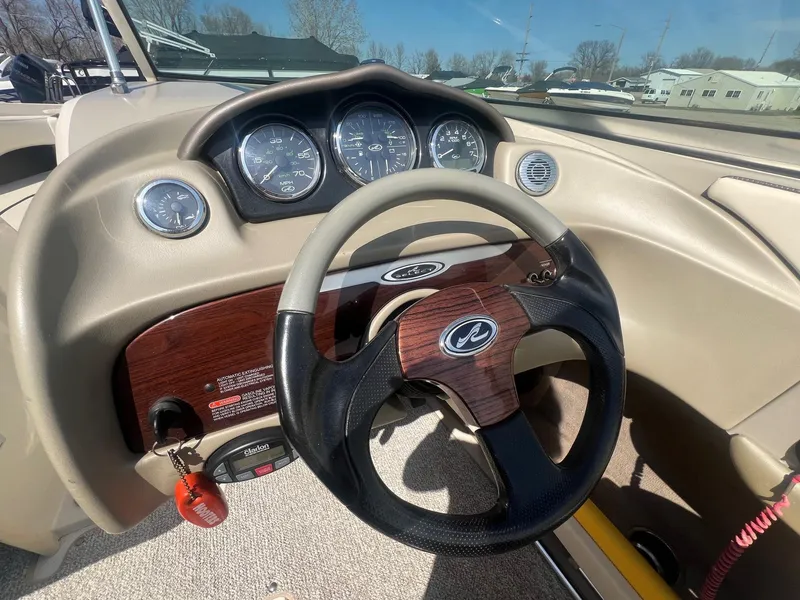 Slide: The Image of 2005 Sea Ray 220 Select boat dashboard with steering wheel and gauges. - 12