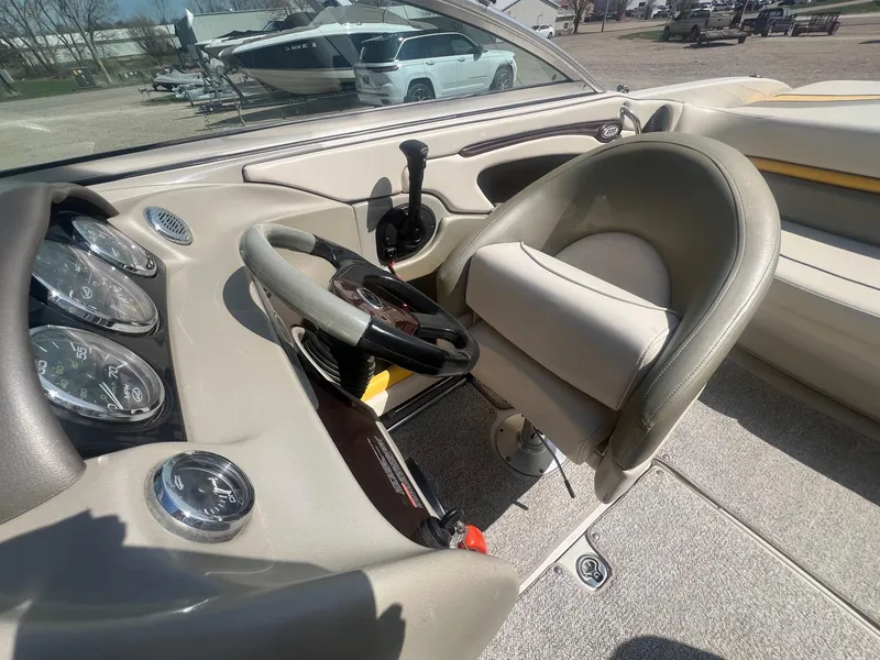 Slide: The Image of 2005 Sea Ray 220 Select boat interior with steering wheel and gauges. - 15