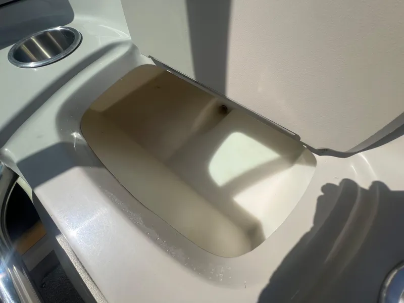 Slide: The Image of 2005 Sea Ray 220 Select boat interior storage compartment with cup holder. - 18