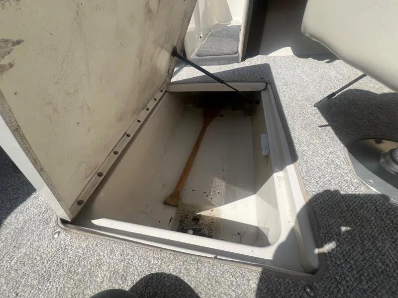 Slide: The Image of Open storage compartment in 2005 Sea Ray 220 Select boat, showing interior space. - 19