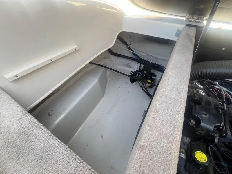 Slide: The Image of Open engine compartment of a 2005 Sea Ray 220 Select boat, showing interior components. - 23