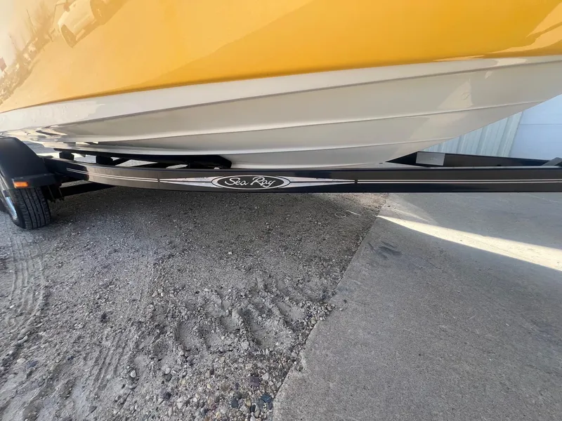 Slide: The Image of 2005 Sea Ray 220 Select boat on trailer, yellow hull, parked on gravel. - 26