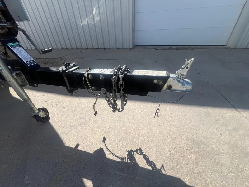 Slide: The Image of Trailer hitch of a 2005 Sea Ray 220 Select boat, with chains and coupler. - 27