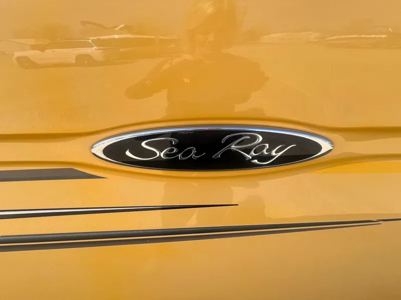 Slide: The Image of Close-up of 2005 Sea Ray 220 Select logo on a yellow surface. - 3