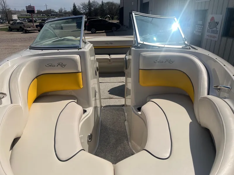 Slide: The Image of 2005 Sea Ray 220 Select boat interior with yellow and white seating, sunny day. - 5