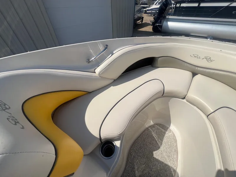 Slide: The Image of 2005 Sea Ray 220 Select boat interior with beige and yellow seating. - 8
