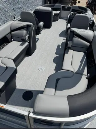 Slide: The Image of 2025 South Bay S224RS pontoon boat interior with gray seating and spacious layout. - 3