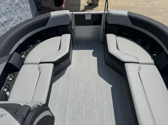 Slide: The Image of 2025 South Bay S224RS pontoon boat interior with gray seating and cup holders. - 4