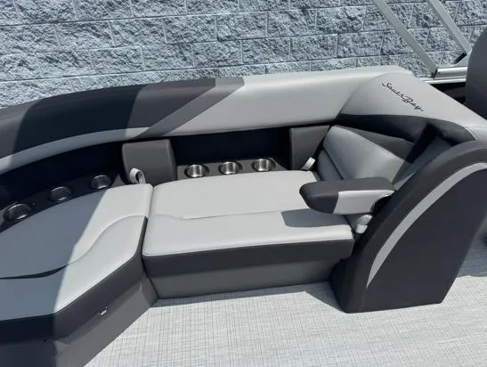 Slide: The Image of 2025 South Bay S224RS boat seating with cup holders, featuring sleek gray and black design. - 5