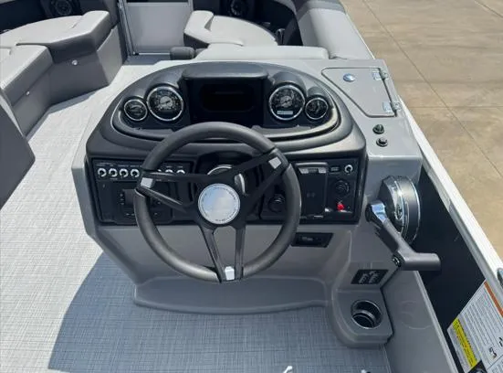 Slide: The Image of 2025 South Bay S224RS boat dashboard with steering wheel and control panel. - 7