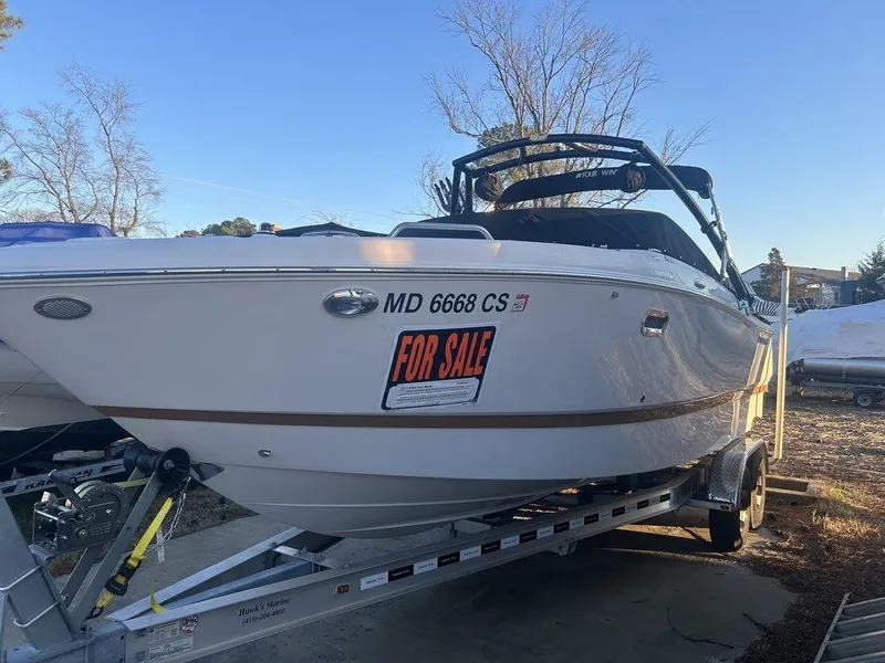 Slide: The Image of 2017 Four Winns H260 boat on trailer, for sale sign visible. - 4