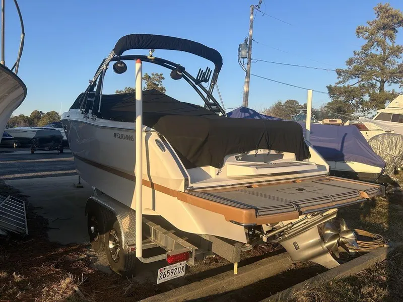 Slide: The Image of 2017 Four Winns H260 boat on trailer, covered and parked outdoors. - 5