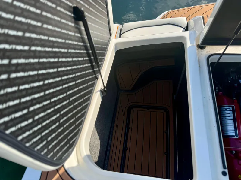 Slide: The Image of Open storage compartment on 2017 Nautique Super Air Nautique GS20 boat. - 10