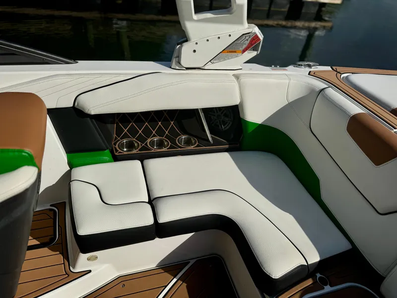 Slide: The Image of 2017 Nautique Super Air Nautique GS20 interior with white and green seating, cup holders, and stylish design. - 12