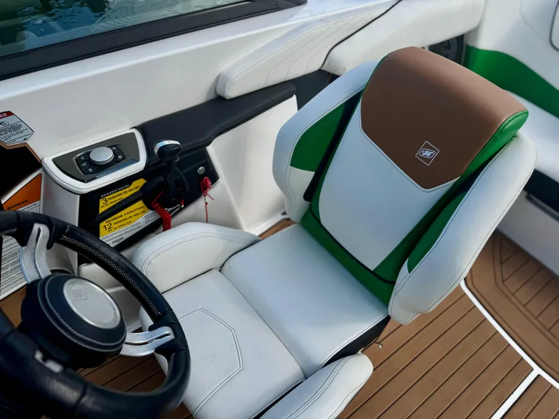 Slide: The Image of 2017 Nautique Super Air Nautique GS20 interior with white and green seating, steering wheel, and controls. - 16