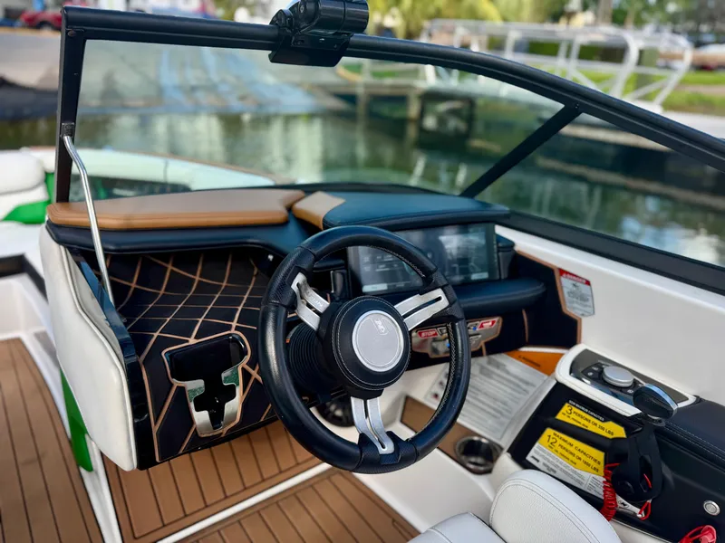 Slide: The Image of 2017 Nautique Super Air Nautique GS20 boat interior with steering wheel and dashboard controls. - 17